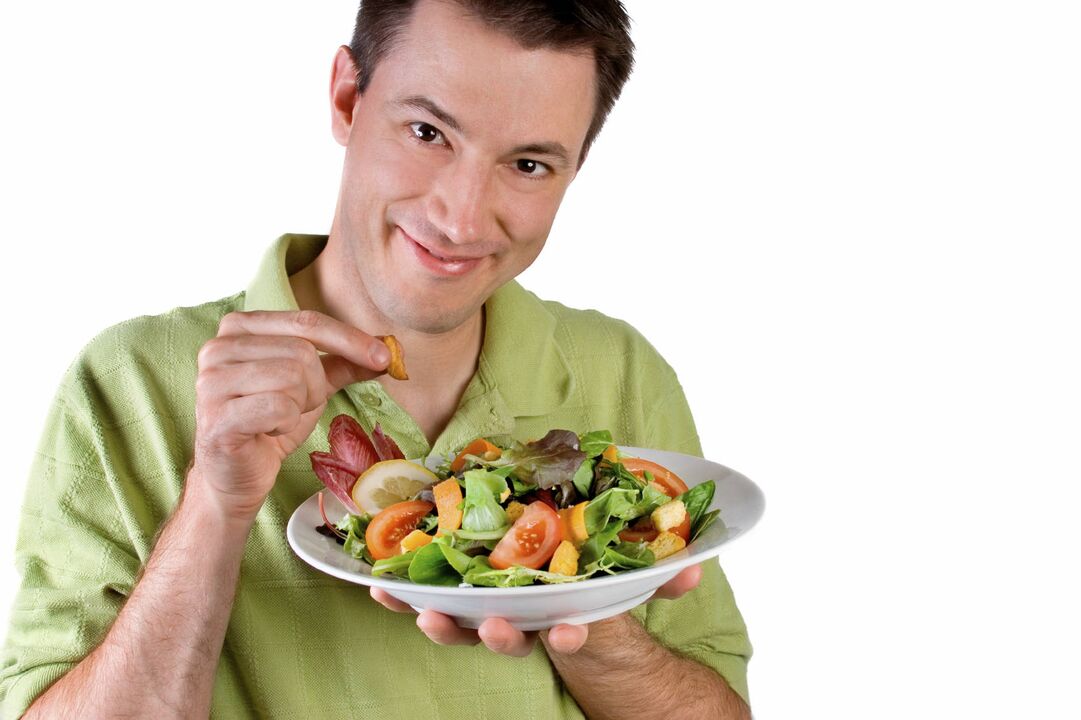 man eats vegetable salad to empower