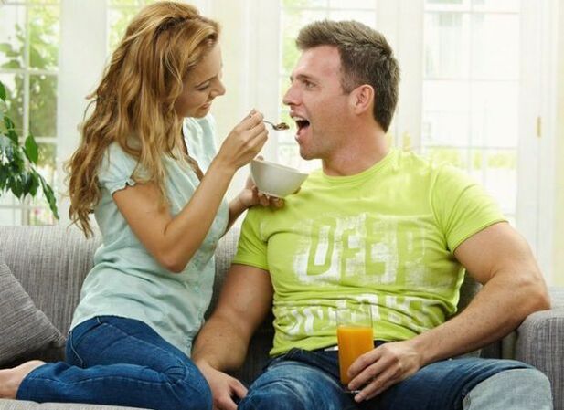 a woman feeds a man potency-enhancing products